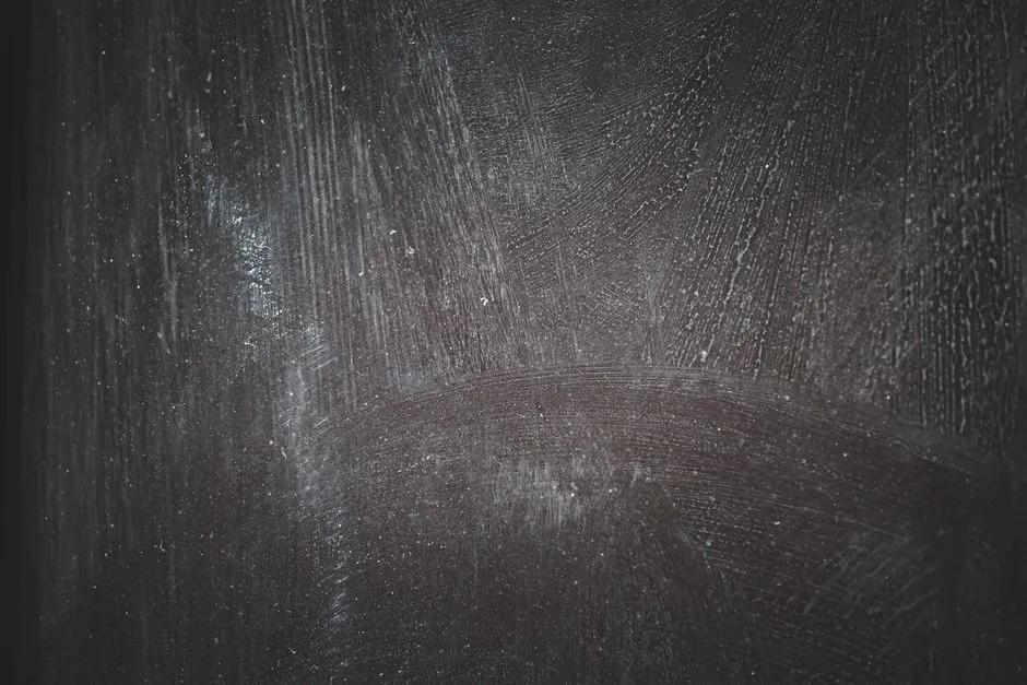 swirl marks and fine scratches visible on dark car paint in sunlight